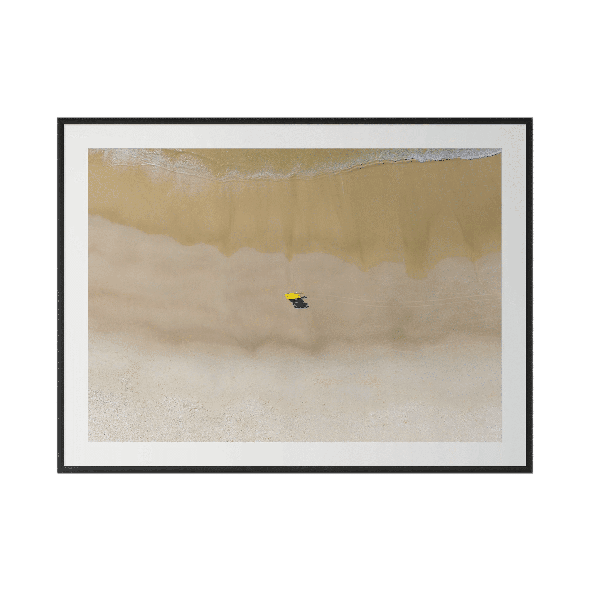 Aerial view of a beach with gentle waves, wet sand, and a single yellow umbrella casting a shadow on the shore; VIGILANCE is stunning Australian photography presented as large-scale statement art in a simple black frame. - The Coastal Edit Australia