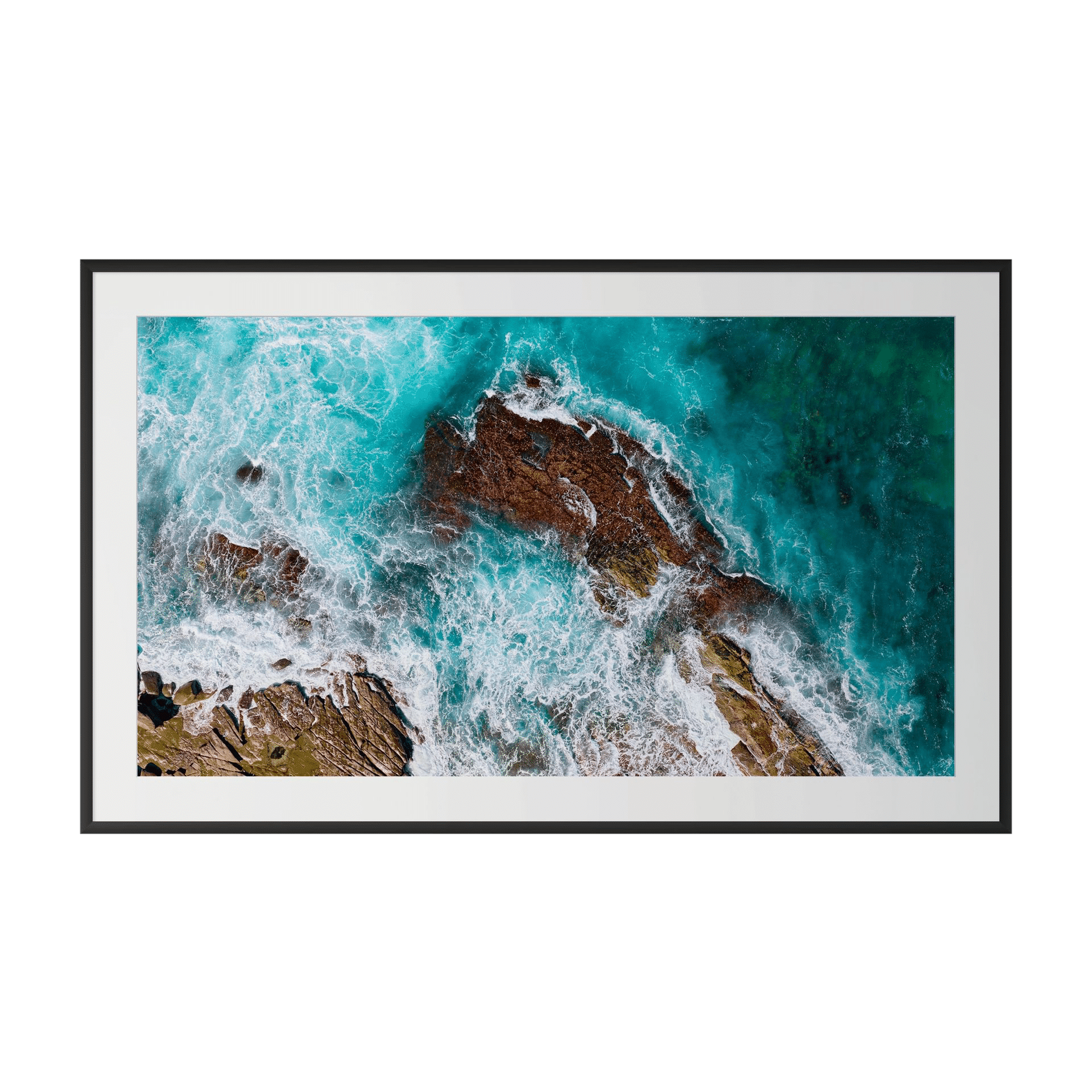 THE CONSTANT is a museum-grade framed aerial photograph capturing striking turquoise ocean waves over rugged brown rocks—an Australian artwork ideal for sophisticated interior design wall art. - The Coastal Edit Australia