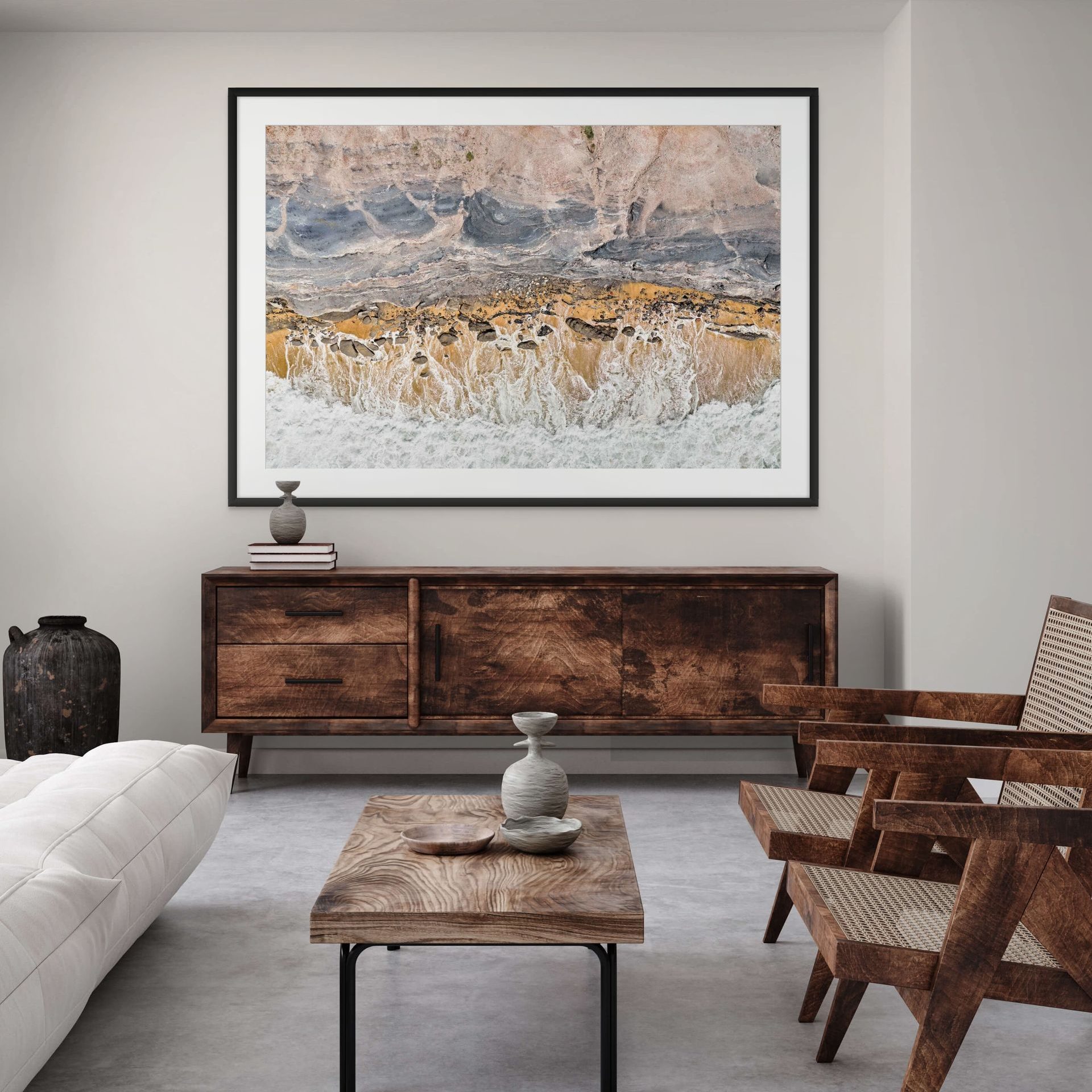 A modern living room with rustic wooden furniture, a white sofa, and EXHALE statement art in earthy tones. Decorative vases on the coffee table and sideboard enhance the EXHALE wall art centrepiece. - The Coastal Edit Australia