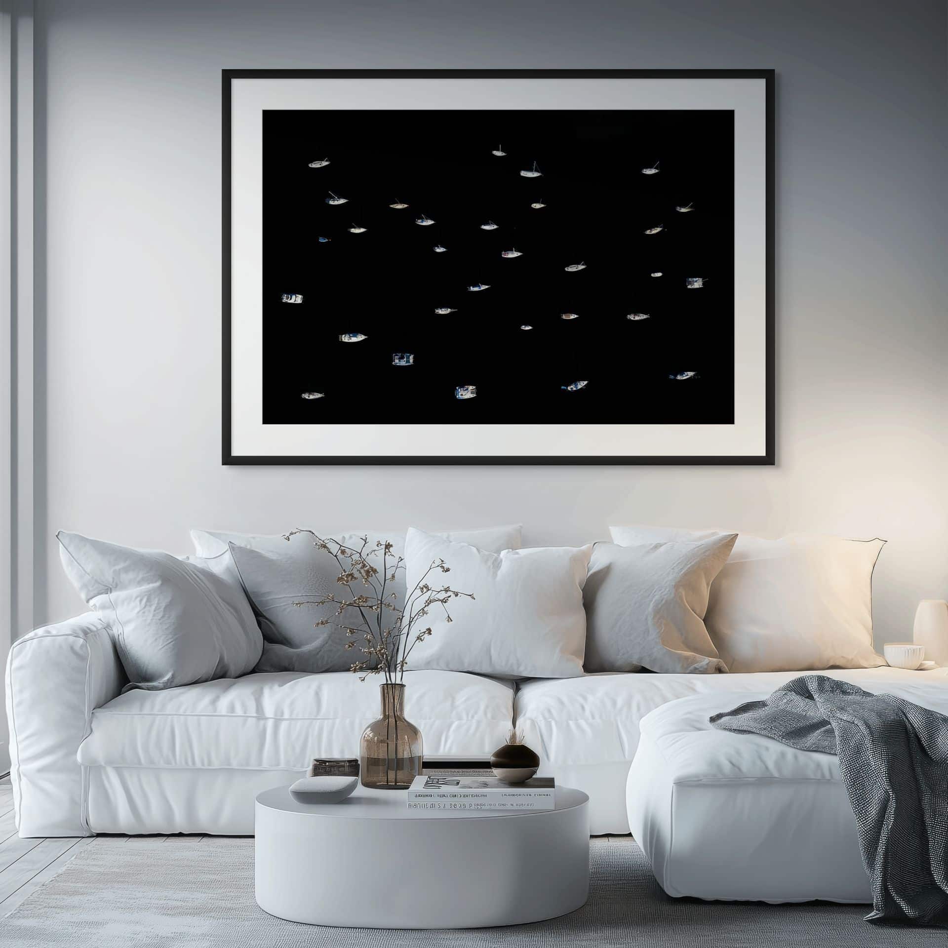 A modern living room featuring the CELESTIAL large-scale statement art in museum-grade framing, displayed on a grey wall above a white sofa with neutral cushions, coastal decor, and a small round table with vases. - The Coastal Edit Australia