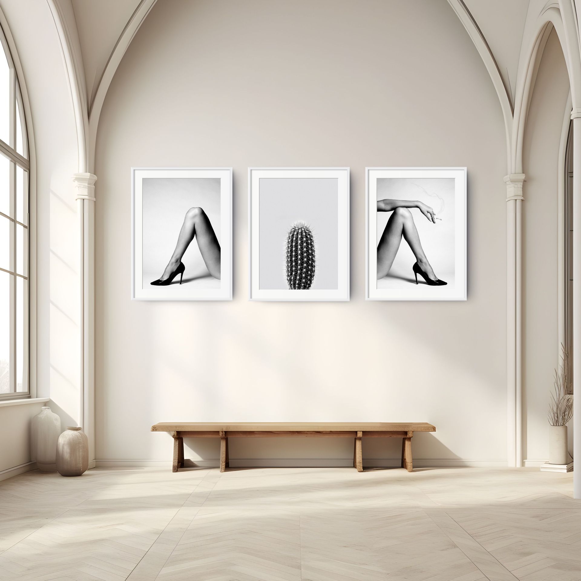 A minimal room with tall arched windows, a wooden bench, and three framed black-and-white art prints from THE RIGHT featuring legs in high heels, a cactus, and a hand holding a cigarette on a light-coloured wall. - The Coastal Edit Australia